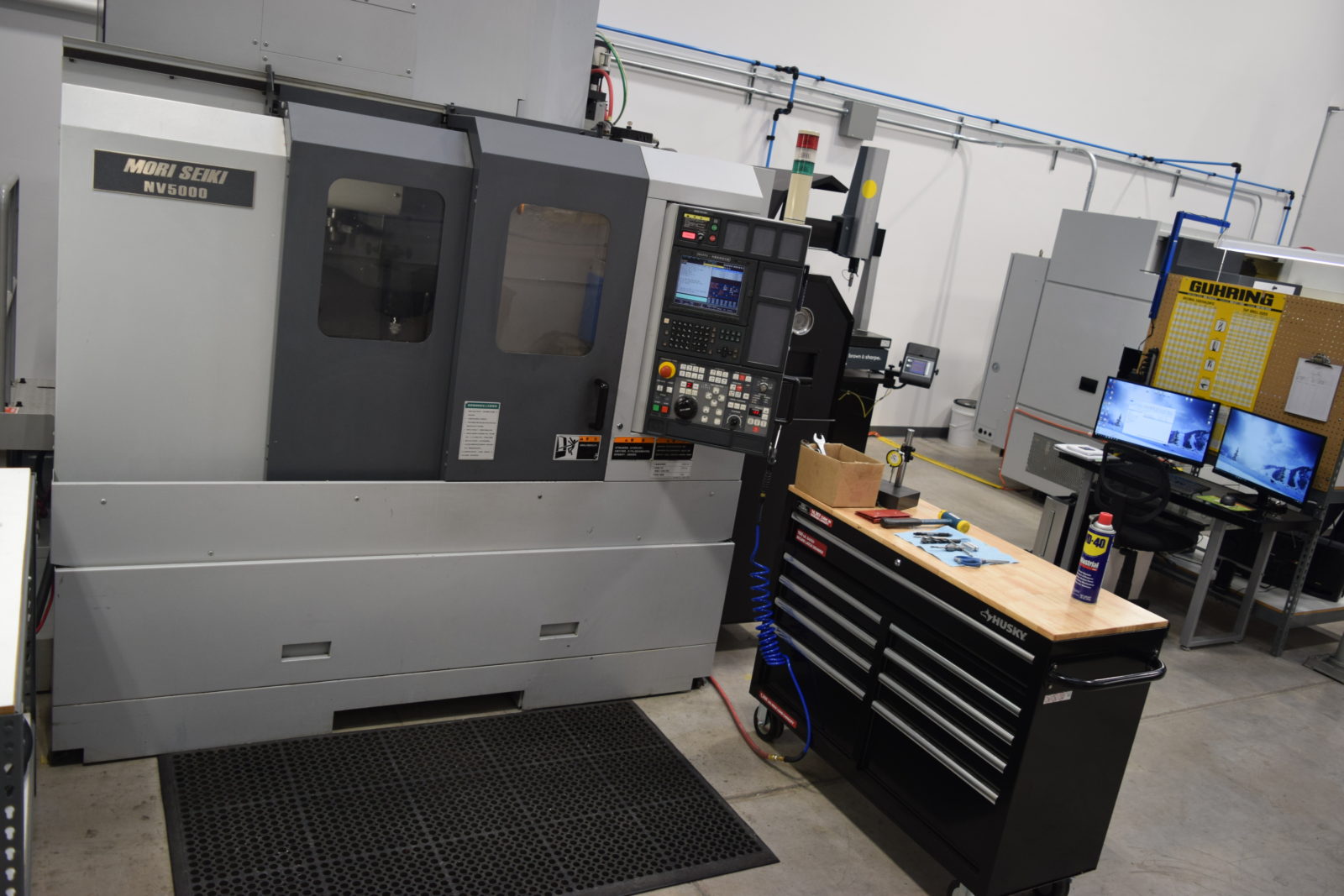 A machine shop with two machines and a table.