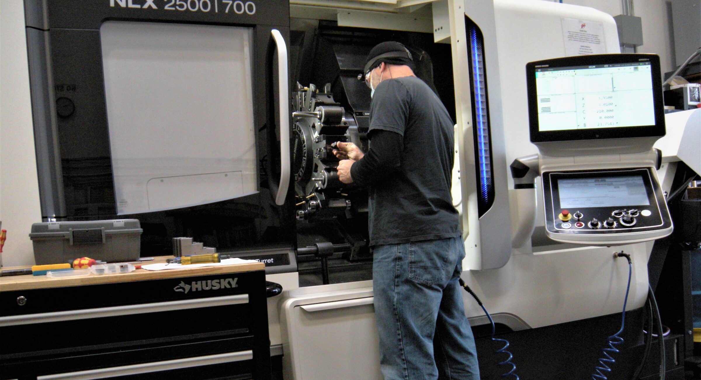 A man working on an industrial machine in a shop.