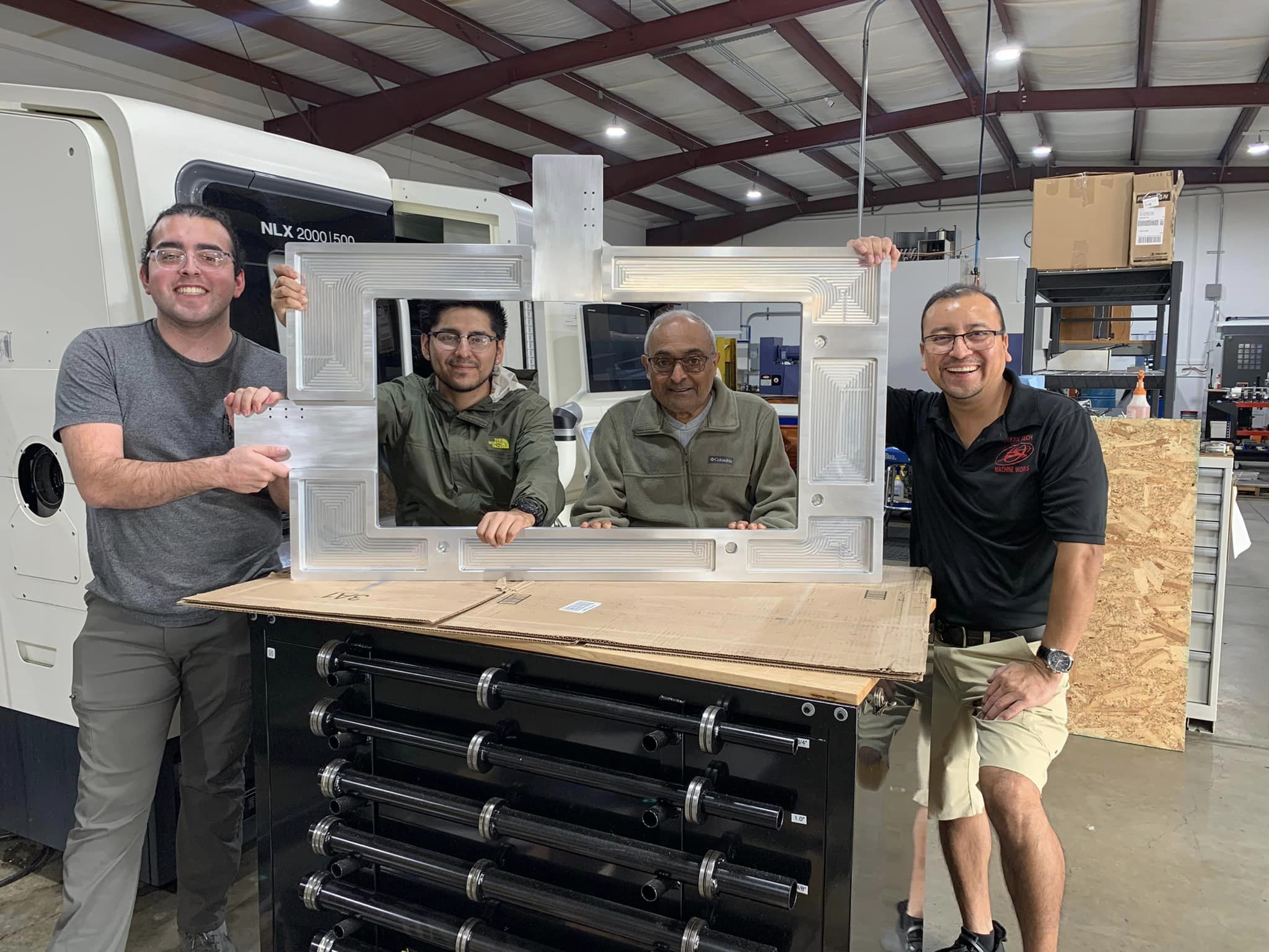 A group of men standing around a table.